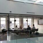 Foreign investors and advisers reviewing corporate bank account documents in a modern office